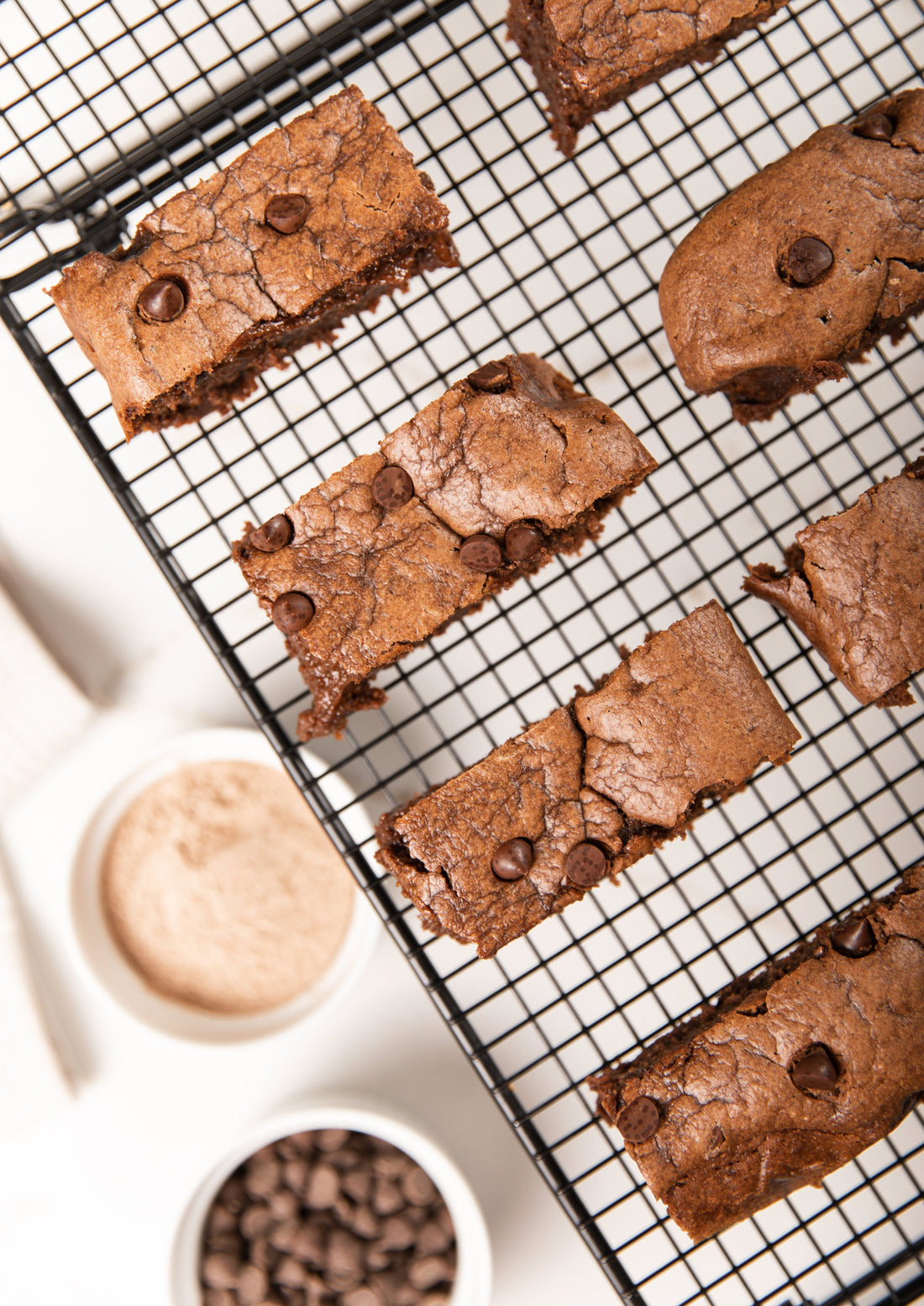 Freshly baked brownies on a cooling rack.