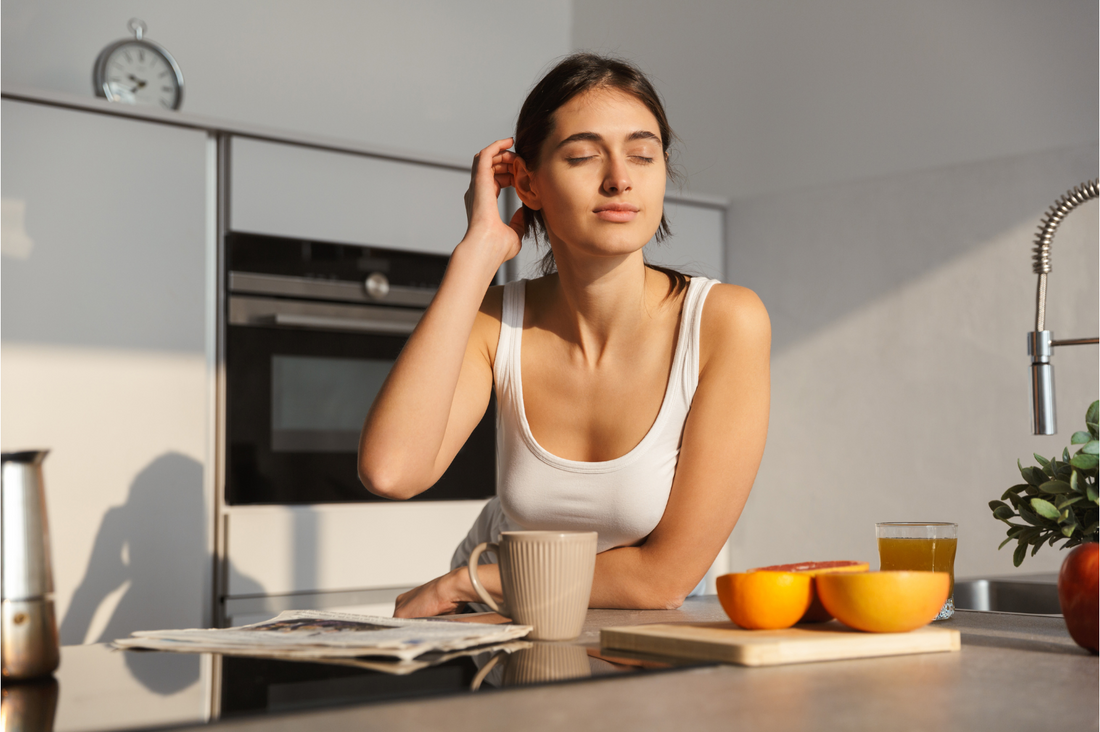 A woman in the sun preparing a healthy drink.